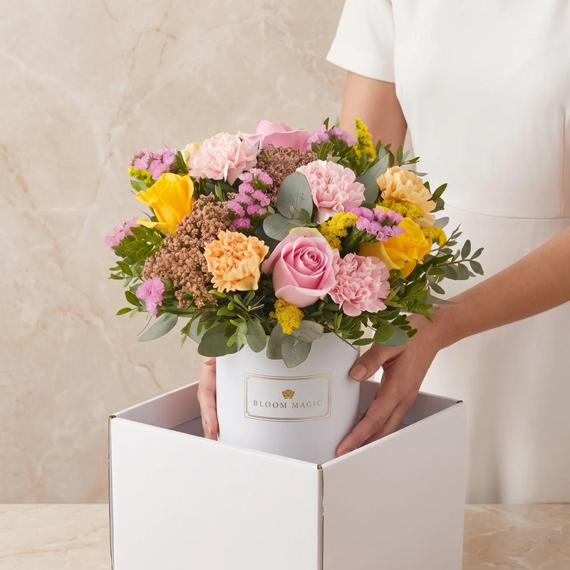 Bloom Magic pink hatbox arrangement with its original branded front label