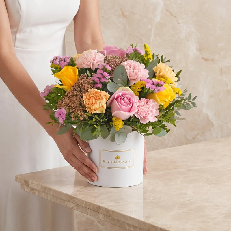 Pink hatbox arrangement left intact with every stem in place