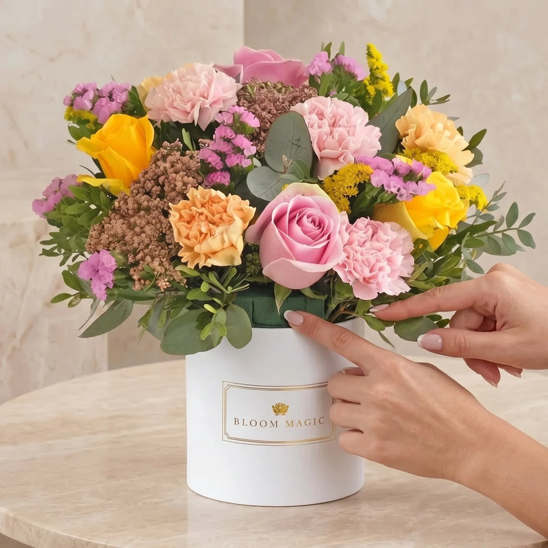 Gently checking the moisture of the floral foam between hatbox stems