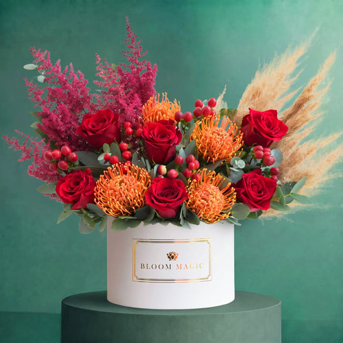 Large Autumn Royale luxury hatbox of deep red roses, orange accents, berries and textured foliage, Bloom Magic